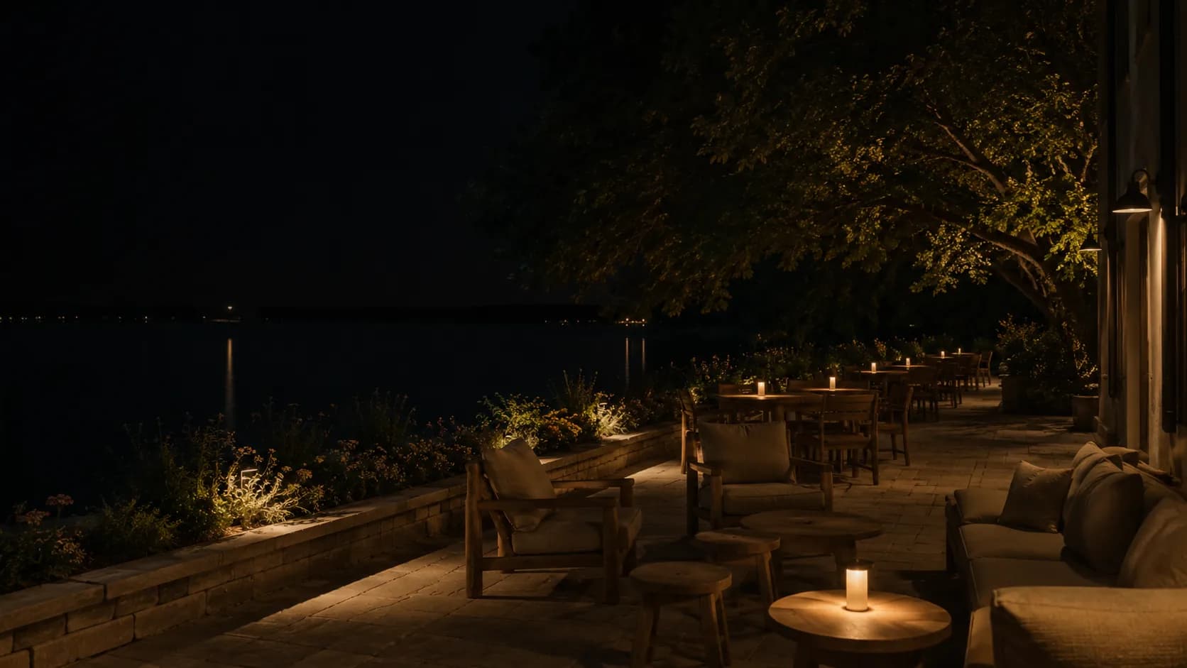 The terrace at night, lit low by lamplight
